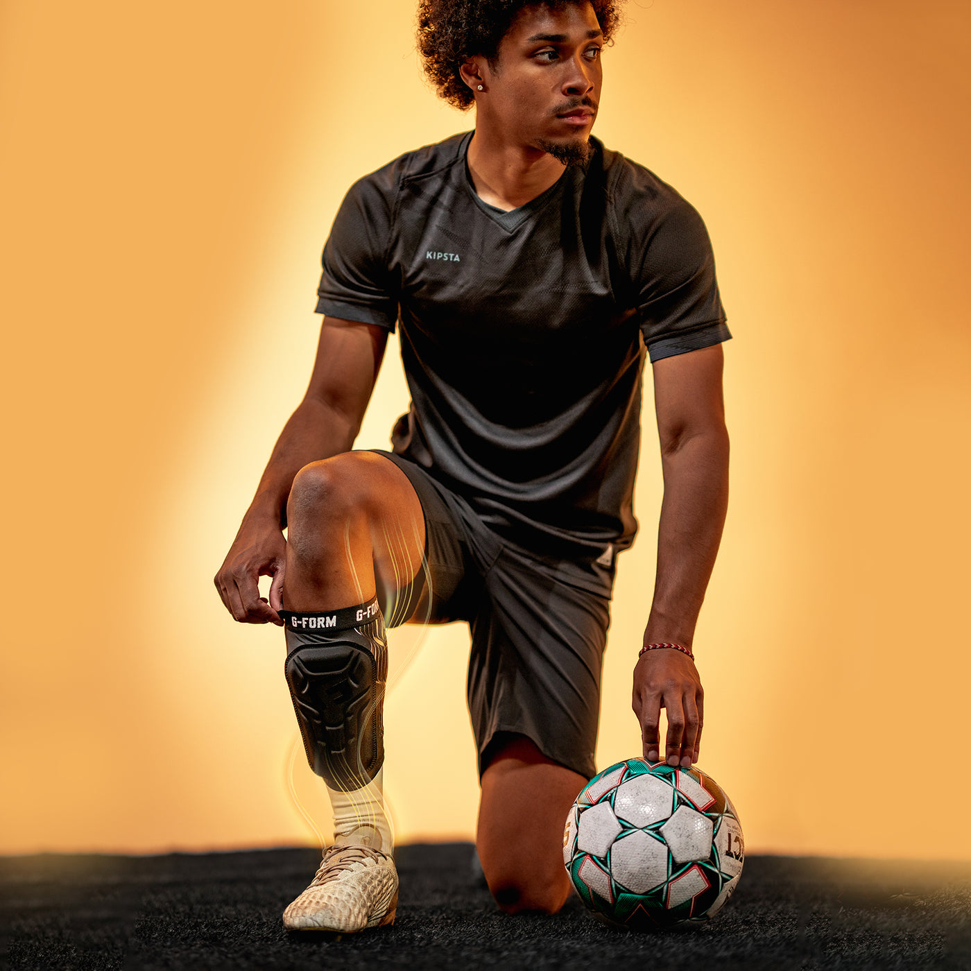 Man in sports attire with a soccer ball on a gradient background