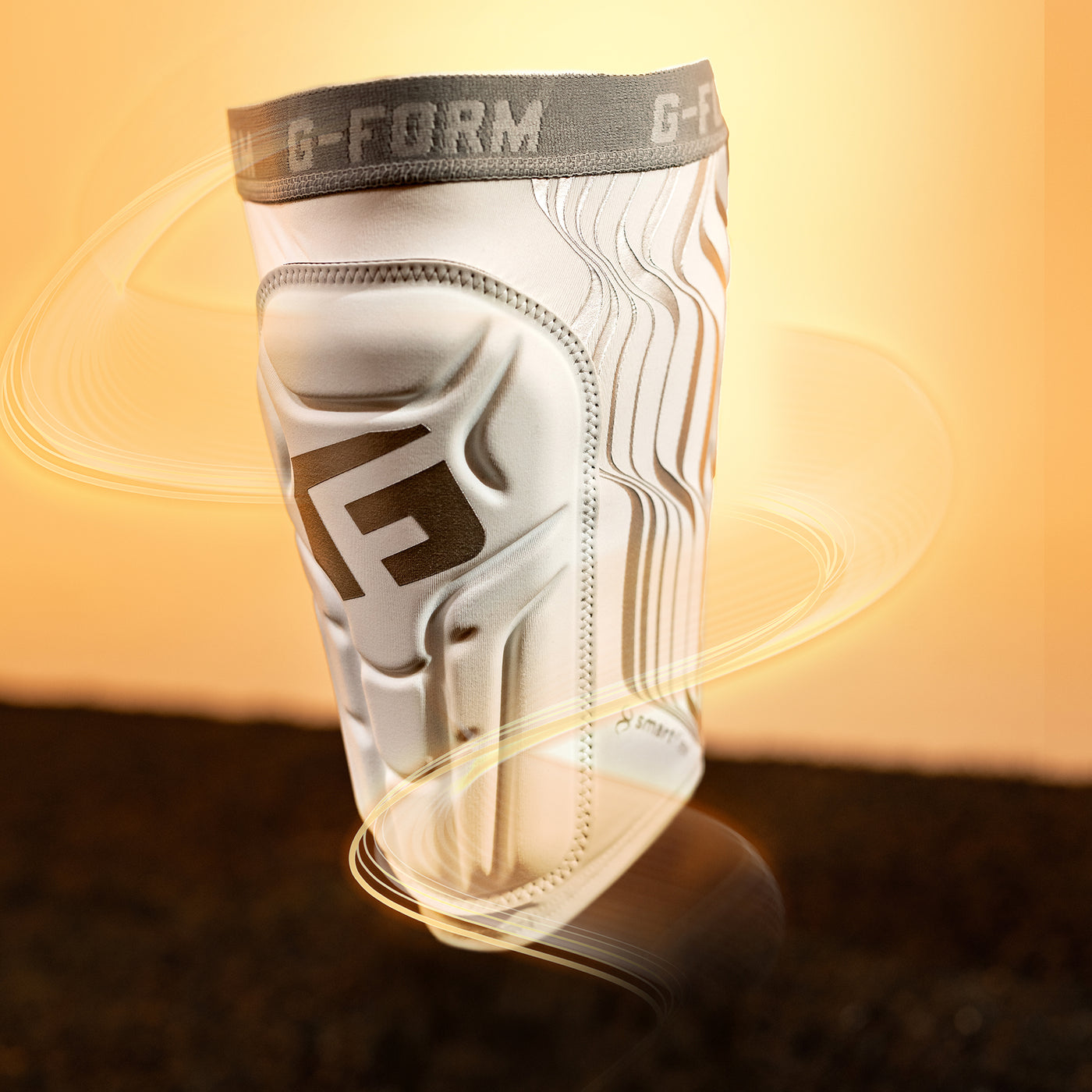 White knee pad with G-Form logo on a blurred background