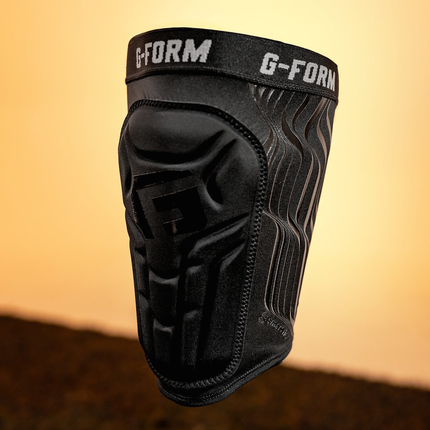 Black G-Form knee pad on a gradient background