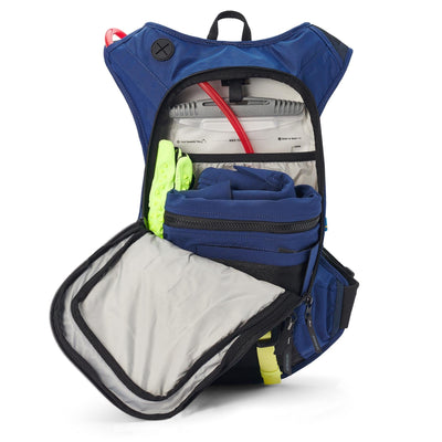 Interior of USWE MOTO Hydro 12L Hydration System Backpack - Factory Blue, showcasing storage compartment with hydration bladder, gloves, and Husqvarna branded item, ideal for outdoor activities, spacious and organized design | 8Lines Shop - Fast Shipping